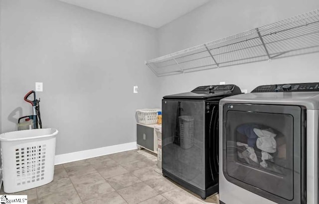 clothes washing area with washing machine and dryer