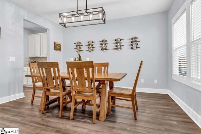 dining area with dark hardwood / wood-style flooring