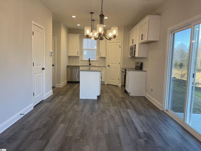 unfurnished living room featuring ceiling fan and a healthy amount of sunlight