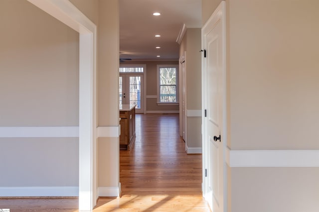 hall with crown molding, french doors, and hardwood / wood-style floors