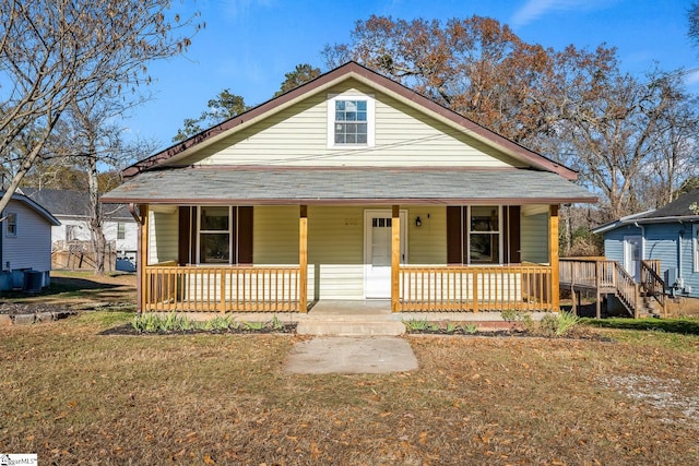 view of front of house with covered porch and central AC unit