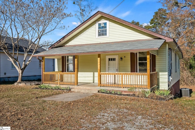 bungalow with a porch and central air condition unit