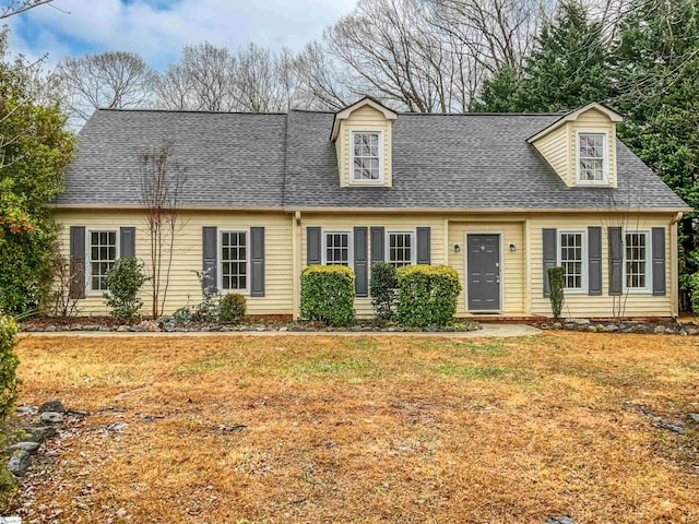 new england style home featuring a front yard