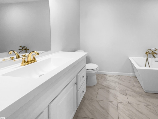 bathroom with a tub to relax in, vanity, and toilet