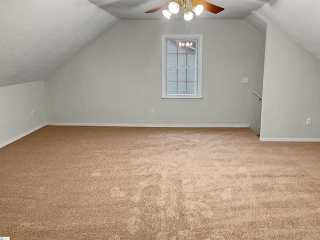 bonus room with lofted ceiling, ceiling fan, and light carpet