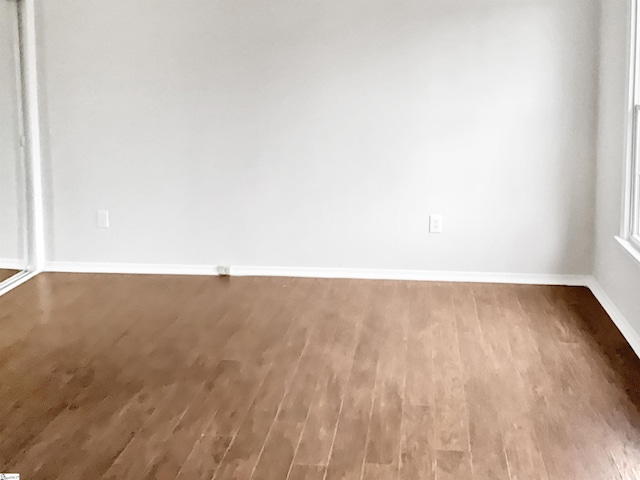 empty room with hardwood / wood-style floors