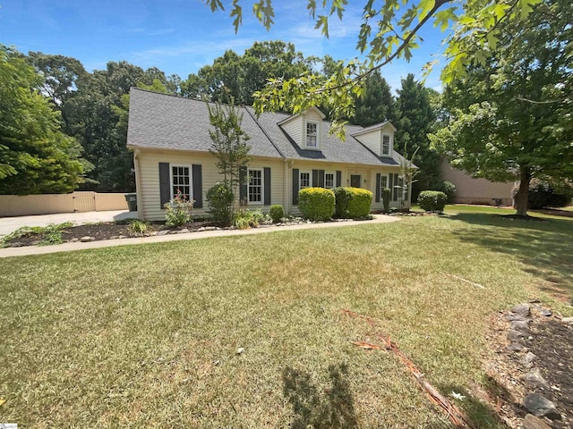 cape cod-style house with a front lawn