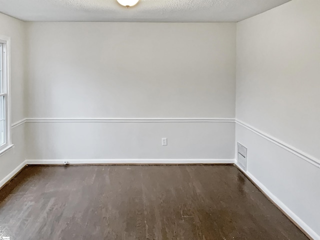 unfurnished room featuring a textured ceiling