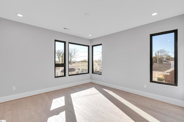 unfurnished room with light hardwood / wood-style floors