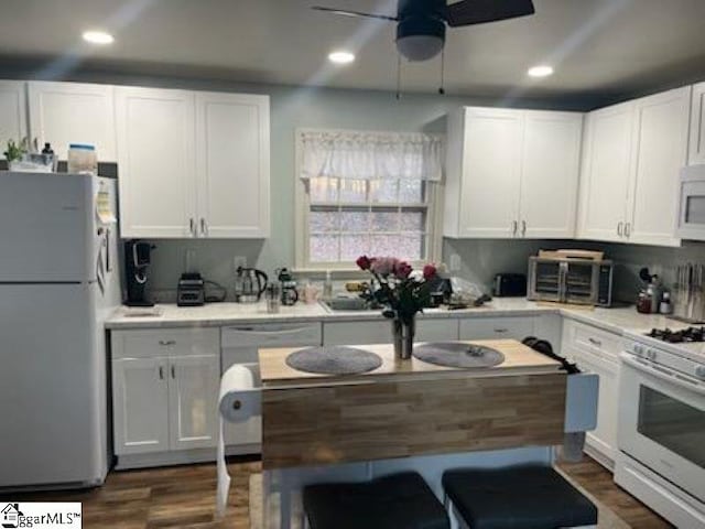 kitchen featuring ceiling fan, white appliances, and white cabinets