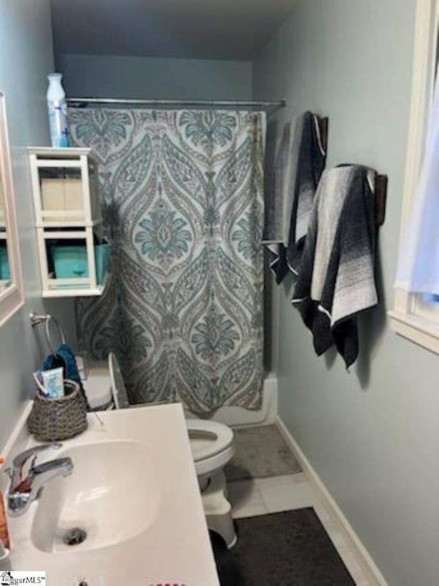 full bathroom featuring tile flooring, toilet, shower / bath combo, and sink