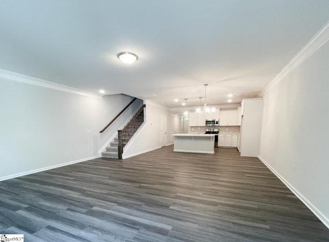 unfurnished living room featuring crown molding, dark hardwood / wood-style floors, and an inviting chandelier