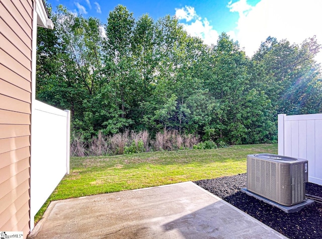 view of yard featuring central AC unit and a patio