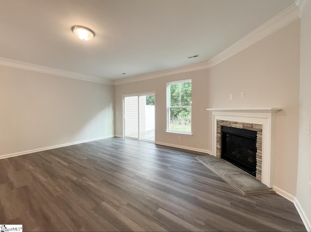 unfurnished living room featuring dark hardwood / wood-style flooring, a stone fireplace, and ornamental molding