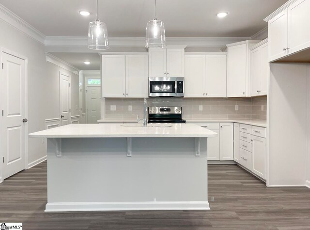 kitchen featuring white cabinetry, pendant lighting, a center island with sink, and appliances with stainless steel finishes