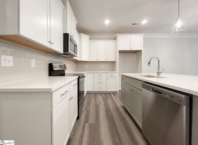 kitchen with tasteful backsplash, sink, white cabinets, hanging light fixtures, and stainless steel appliances