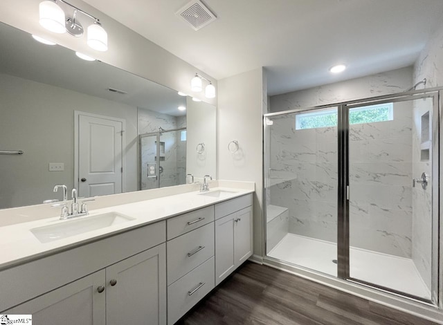 bathroom featuring vanity, a shower with door, and hardwood / wood-style floors