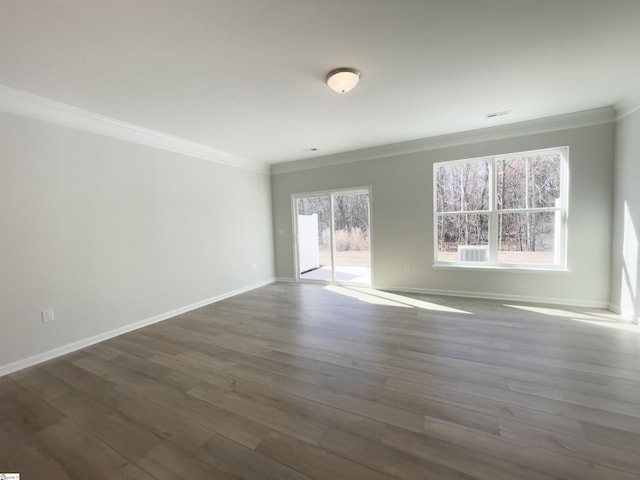 unfurnished room featuring plenty of natural light, wood-type flooring, and crown molding