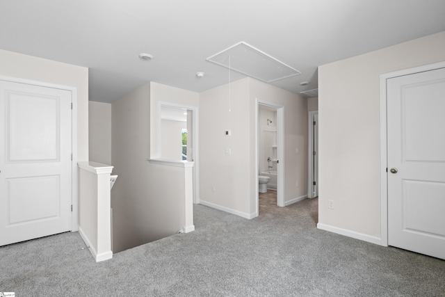 interior space with attic access and baseboards