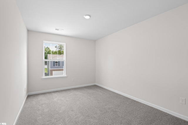 carpeted spare room with baseboards