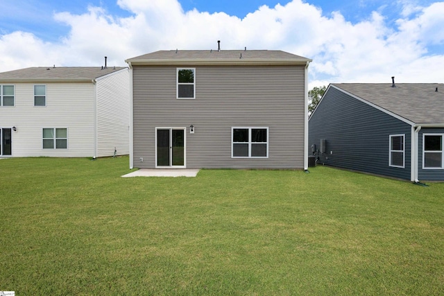 back of property with a patio area and a yard