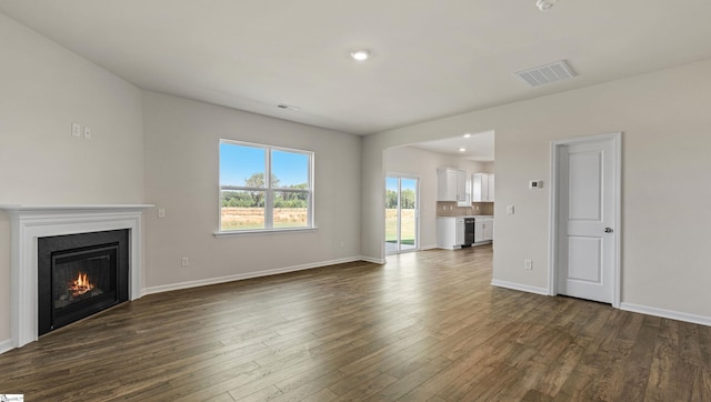 unfurnished living room featuring dark wood-type flooring