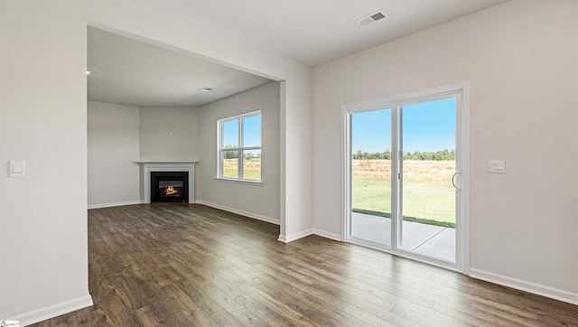 unfurnished living room with dark hardwood / wood-style floors