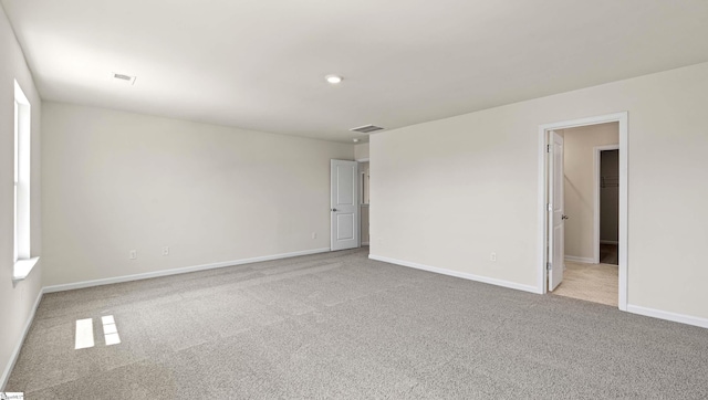 unfurnished room featuring light colored carpet