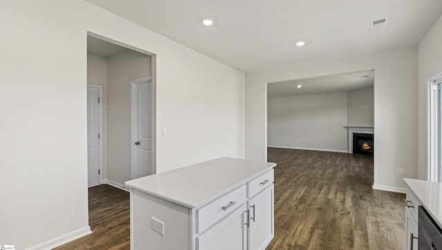 kitchen with dishwasher, white cabinets, dark wood-type flooring, and a kitchen island