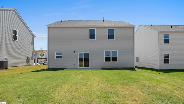 back of house with a lawn, central air condition unit, and a patio