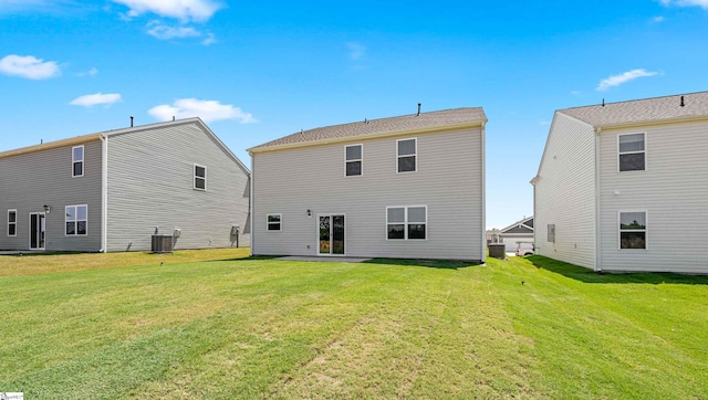 rear view of house featuring a patio area, a yard, and central AC unit