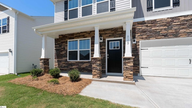 doorway to property featuring a garage and covered porch