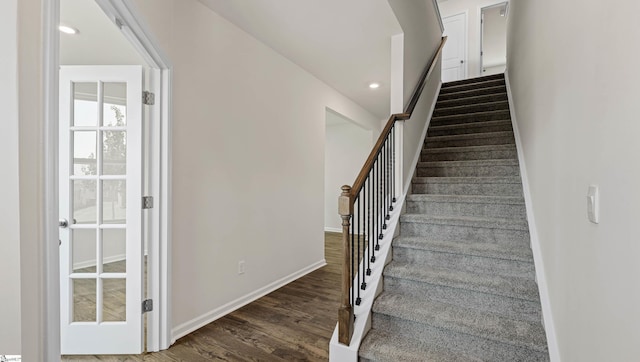 stairway featuring wood-type flooring