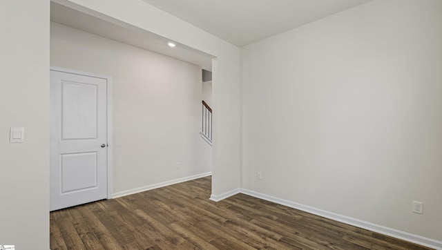 empty room with dark hardwood / wood-style floors