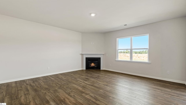 unfurnished living room featuring dark hardwood / wood-style flooring