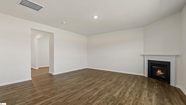 unfurnished living room featuring dark hardwood / wood-style floors