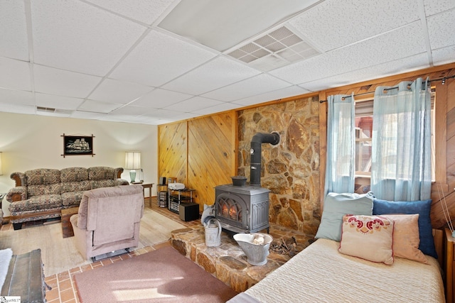 728 Tall Oak Trl, Seneca, SC 29678 - living room with wood walls, a wood stove, light hardwood / wood-style flooring, and a paneled ceiling