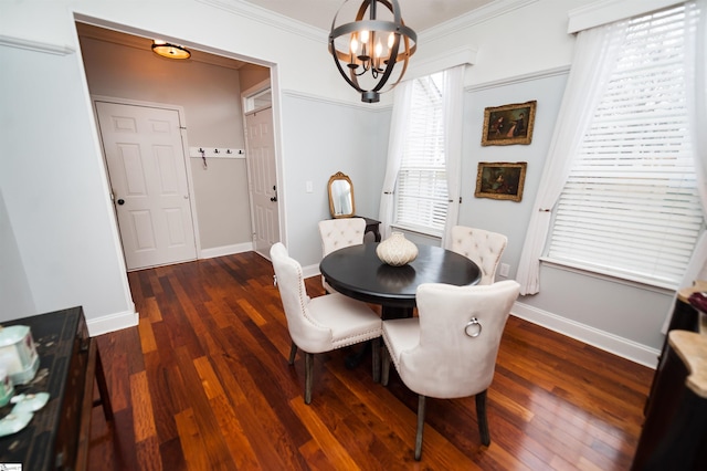 dining area featuring an inviting chandelier, dark wood-type flooring, and ornamental molding