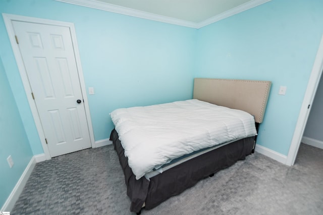 bedroom featuring ornamental molding and dark carpet