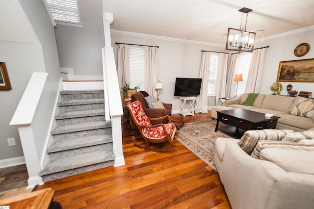 living room featuring a notable chandelier, crown molding, and dark hardwood / wood-style floors