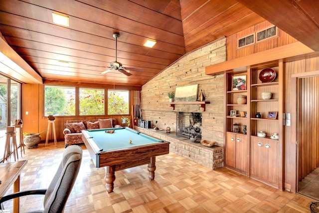 rec room featuring billiards, a fireplace, a healthy amount of sunlight, and wooden walls