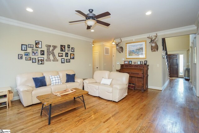 living room with light hardwood / wood-style flooring, ceiling fan, and ornamental molding