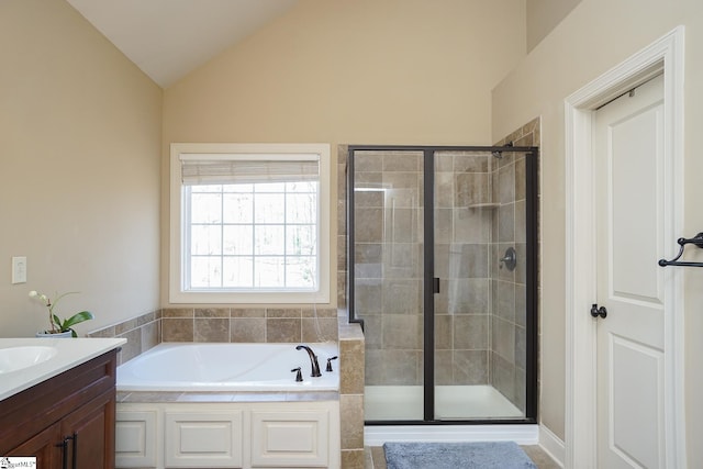 bathroom featuring lofted ceiling, separate shower and tub, and vanity