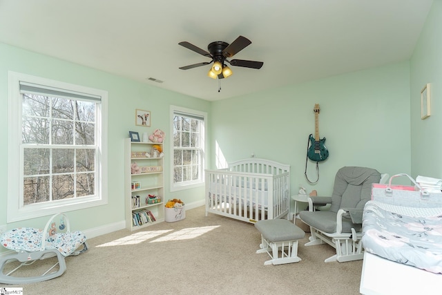 bedroom featuring ceiling fan and light carpet