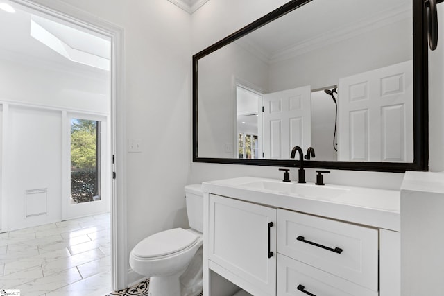 bathroom with tile floors, vanity with extensive cabinet space, toilet, and ornamental molding