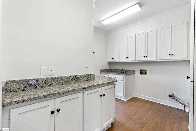 laundry area with cabinets, hookup for a washing machine, ornamental molding, dark hardwood / wood-style flooring, and sink