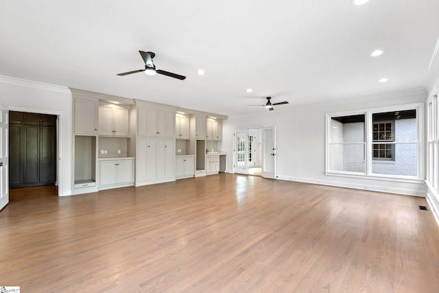 unfurnished living room featuring ceiling fan, crown molding, light wood-type flooring, and french doors