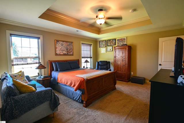 bedroom featuring carpet, ceiling fan, a raised ceiling, and crown molding