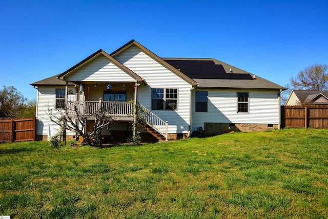 back of house with a yard and ceiling fan