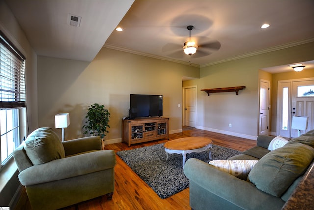 living room with ornamental molding, plenty of natural light, ceiling fan, and hardwood / wood-style floors